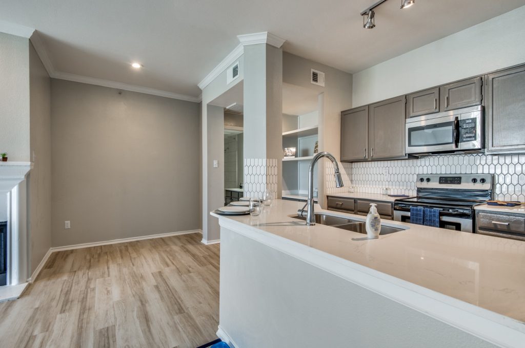 a kitchen with a stove, microwave and refrigerator at The  Montgomery